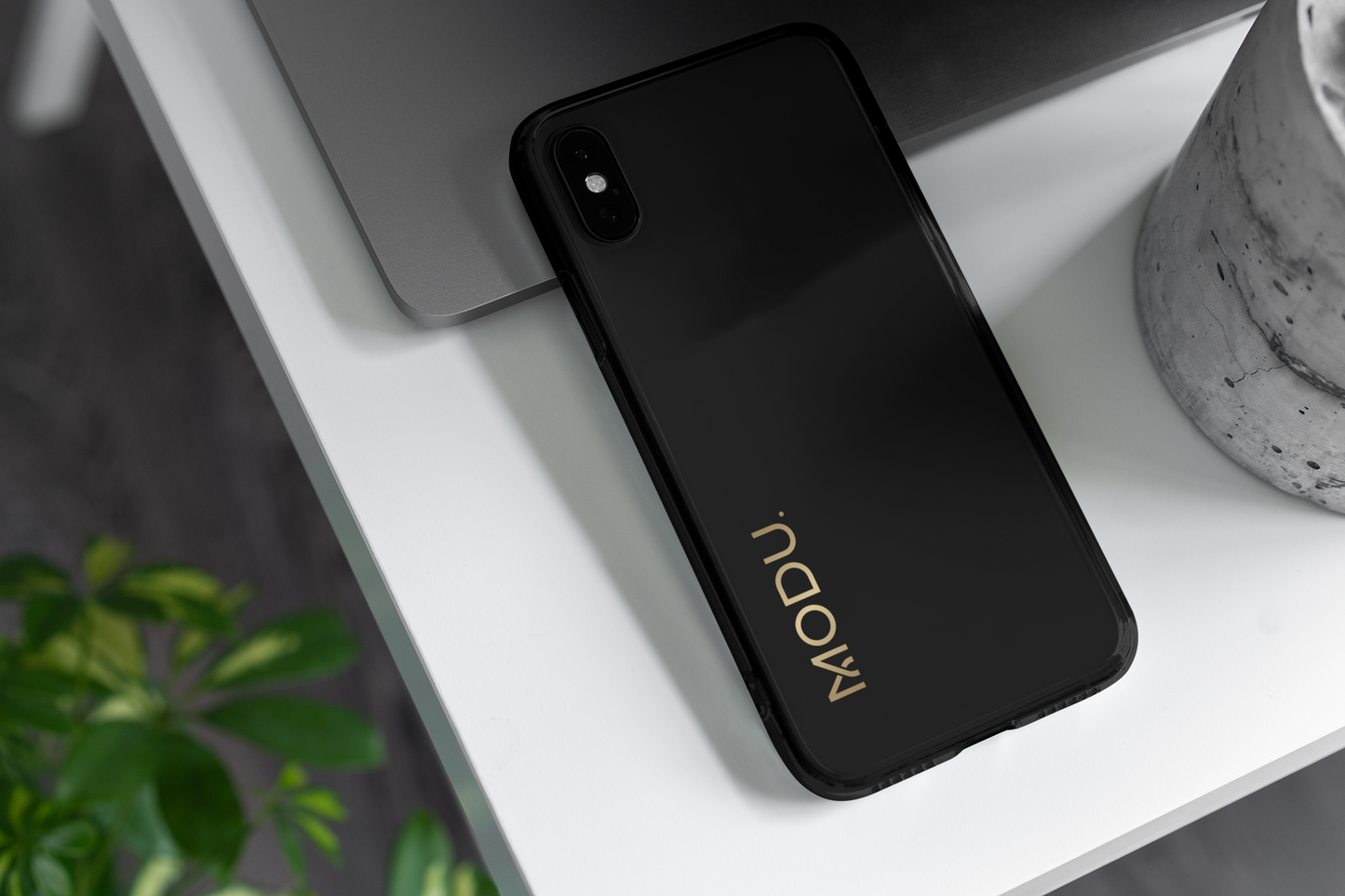 Black phone case with 'MODU' branding